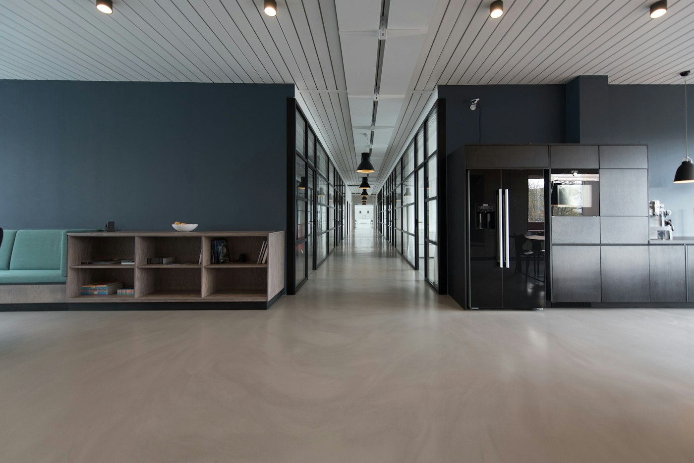Bright institutional office corridor with glass partitions